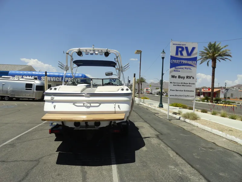 Slide: The Image of 2006 MasterCraft X-45 boat parked near RV dealership under clear sky. - 26
