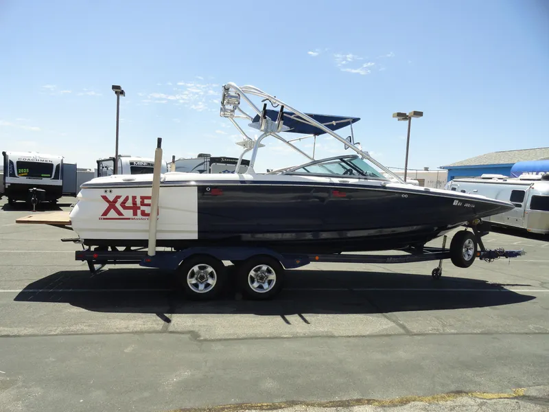 Slide: The Image of 2006 MasterCraft X-45 boat on trailer in parking lot, side view. - 5