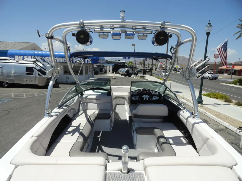 Slide: The Image of 2006 MasterCraft X-45 boat interior with seating, dashboard, and wakeboard tower in a sunny setting. - 6