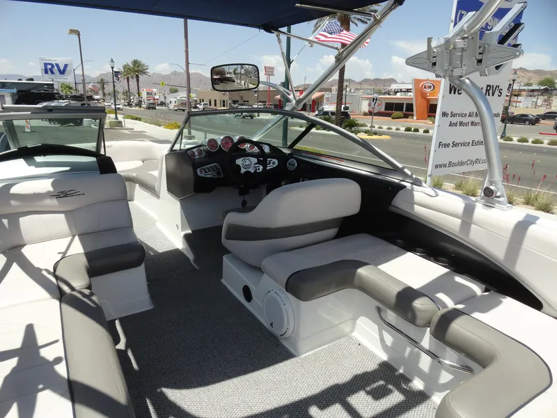 Slide: The Image of 2006 MasterCraft X-45 boat interior with seating and dashboard, parked near RV dealership. - 7