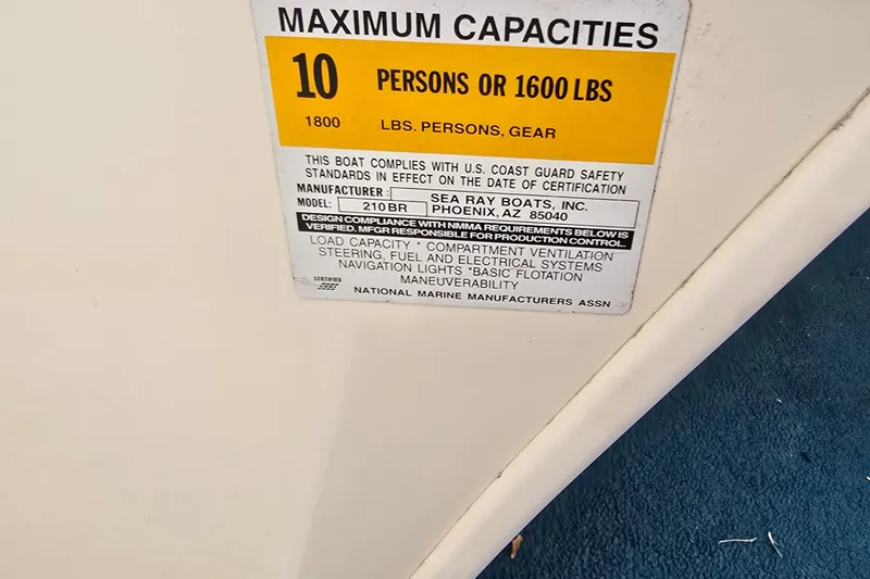 Slide: The Image of 1998 Sea Ray 210br capacity label, maximum 10 persons or 1600 lbs, compliance details. - 10