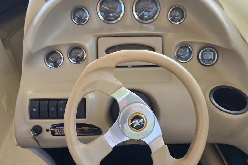 Slide: The Image of 1998 Sea Ray 210br dashboard with steering wheel and instrument gauges. - 6