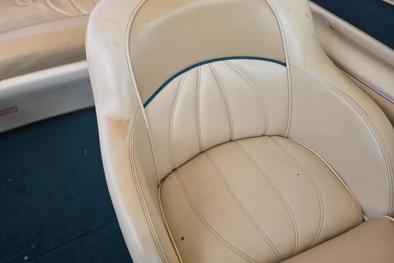 Slide: The Image of 1998 Sea Ray 210br boat seat with white upholstery and blue accent. - 8