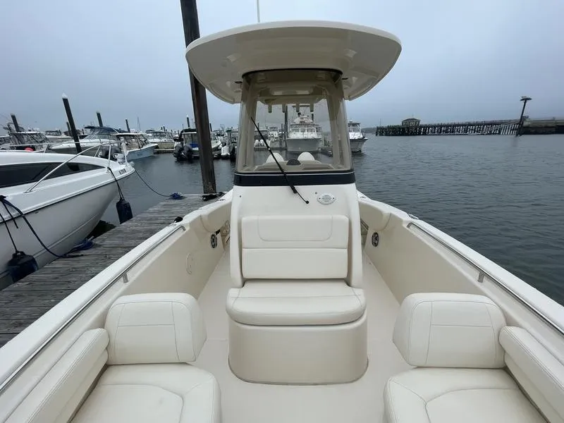 Slide: The Image of 2026 Grady-White 257 Fisherman boat docked at marina, featuring spacious seating. - 2