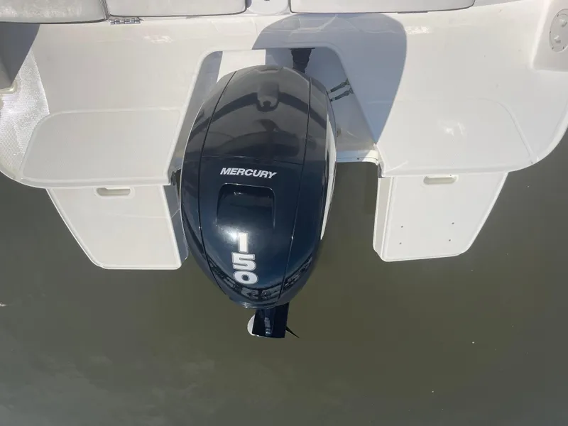 Slide: The Image of 2023 Bayliner DX 2200 with Mercury 150 outboard motor on water. - 5