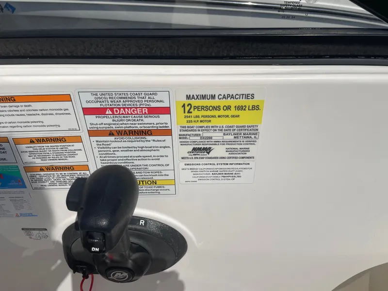 Slide: The Image of Bayliner DX 2200 boat capacity label, 2023 model, maximum 12 persons or 1692 lbs. - 9