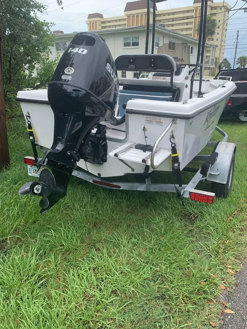 Slide: The Image of 2015 Key Largo 180 Center Console boat with Suzuki outboard motor on trailer. - 1