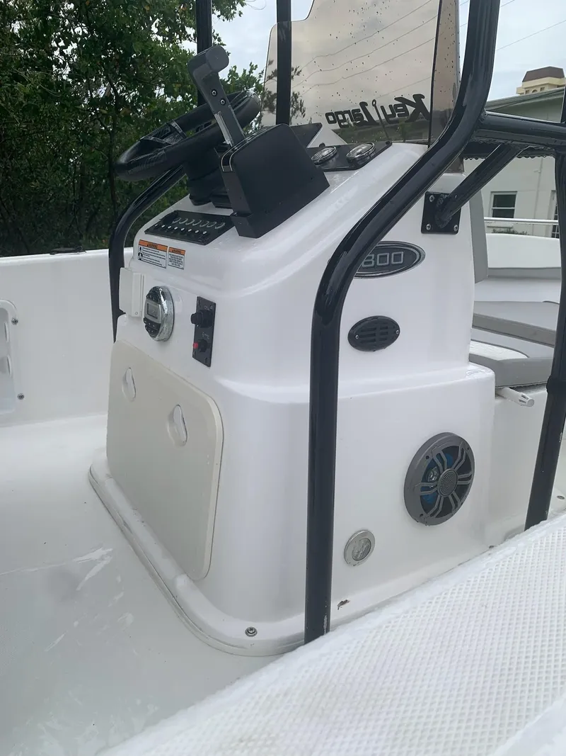 Slide: The Image of 2015 Key Largo 180 Center Console boat interior with steering controls and speaker. - 14