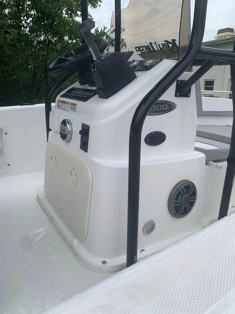 Slide: The Image of 2015 Key Largo 180 Center Console boat interior with steering controls and seating. - 26
