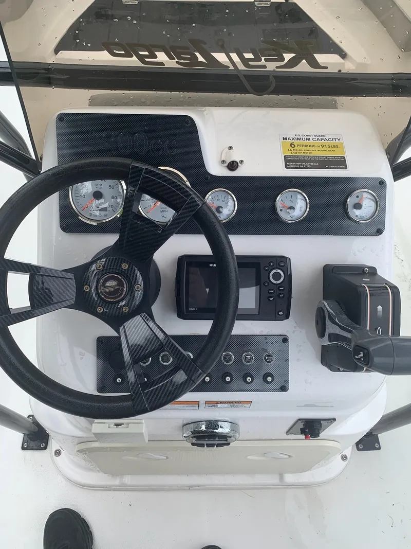 Slide: The Image of 2015 Key Largo 180 Center Console dashboard with steering wheel, gauges, and controls. - 4