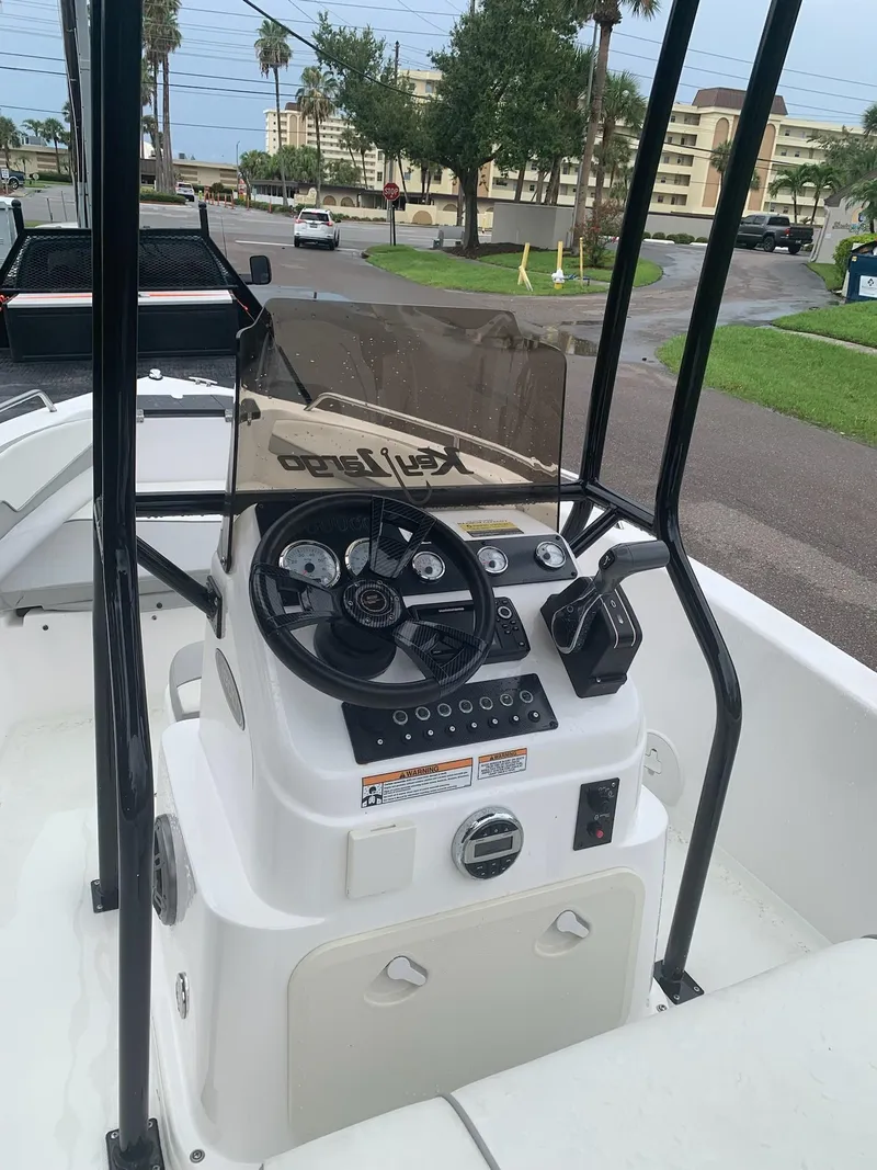 Slide: The Image of 2015 Key Largo 180 Center Console boat dashboard with steering wheel and controls. - 5