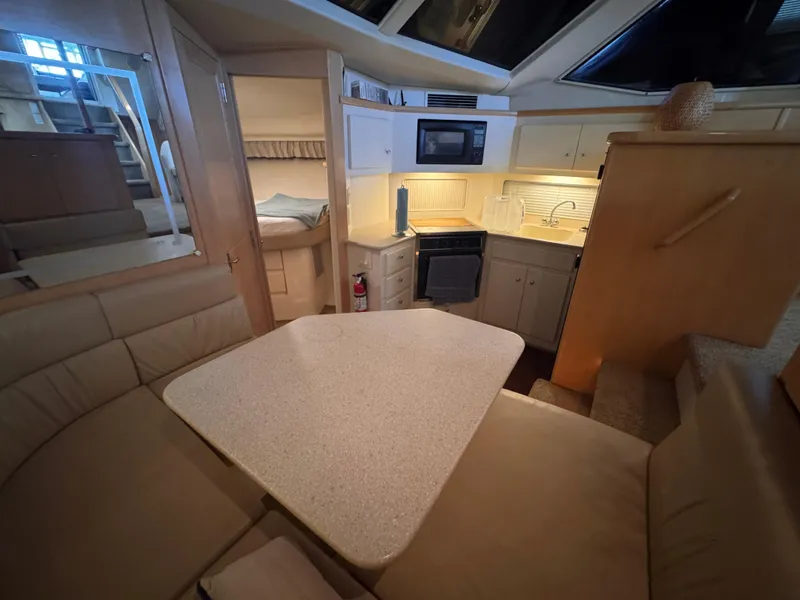 Slide: The Image of Interior of 1998 Carver 405 Aft Cabin yacht with kitchen and dining area. - 13