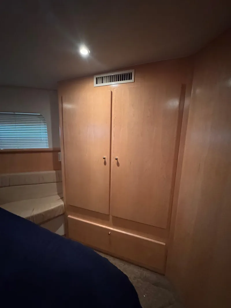 Slide: The Image of 1998 Carver 405 Aft Cabin interior with wooden cabinetry and seating area. - 21