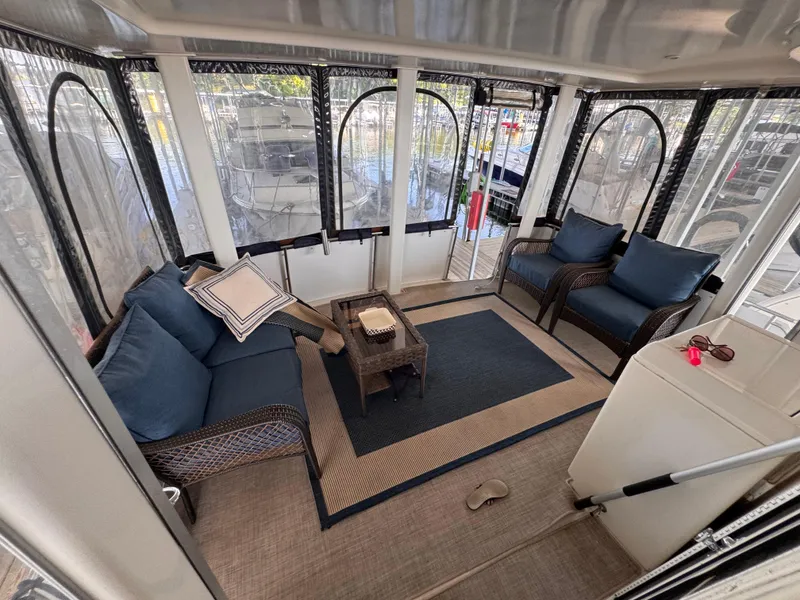 Slide: The Image of 1998 Carver 405 Aft Cabin interior with wicker furniture and blue cushions. - 25