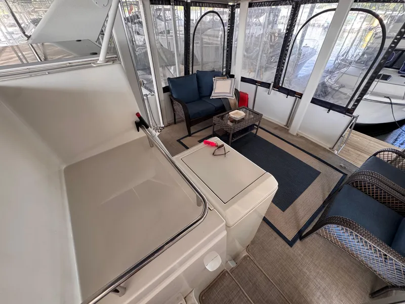 Slide: The Image of 1998 Carver 405 Aft Cabin interior with seating area and enclosed deck. - 28