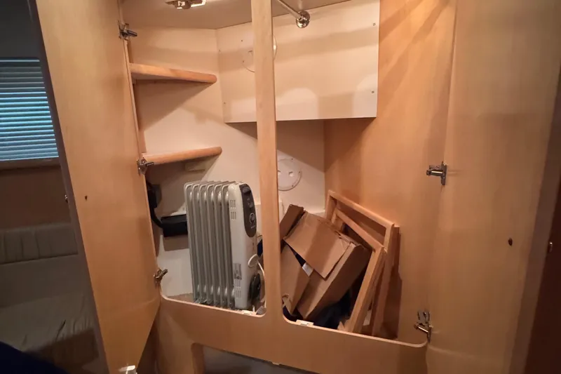 Slide: The Image of Interior storage of 1998 Carver 405 Aft Cabin with heater and shelves. - 32
