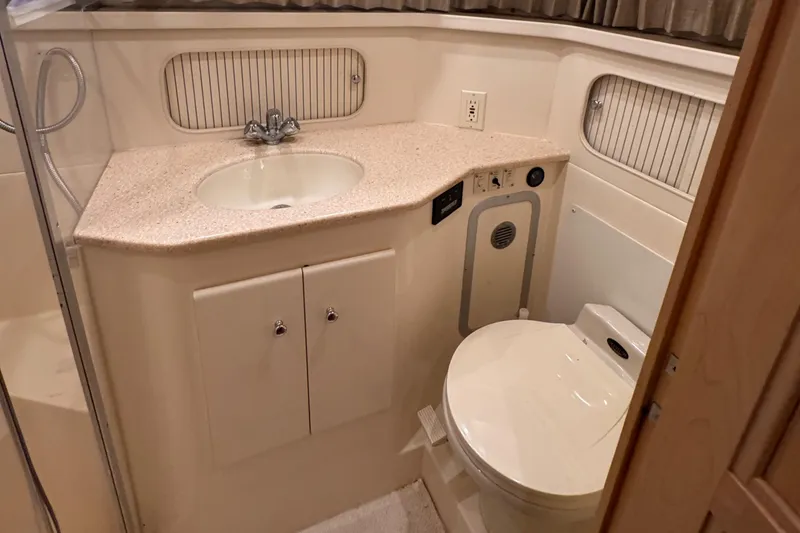Slide: The Image of 1998 Carver 405 Aft Cabin bathroom with sink, toilet, and shower. - 34