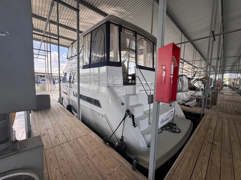 Slide: The Image of 1998 Carver 405 Aft Cabin yacht docked in a covered marina. - 4