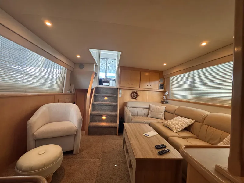 Slide: The Image of Interior of 1998 Carver 405 Aft Cabin yacht with cozy seating and modern decor. - 7