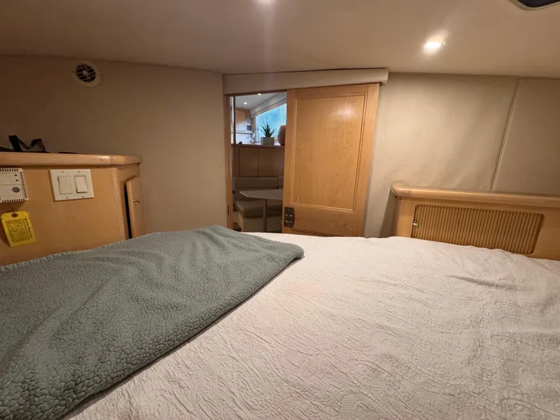 Slide: The Image of Interior of 1998 Carver 405 Aft Cabin with cozy bed and wooden accents. - 9