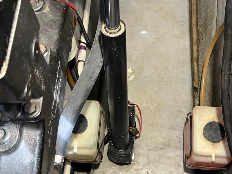 Slide: The Image of Engine compartment of a 1999 Sea Ray 400 Sundancer with hydraulic components and wiring. - 11