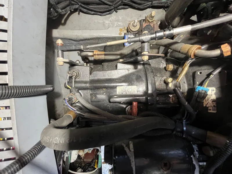 Slide: The Image of Engine compartment of a 1999 Sea Ray 400 Sundancer boat, showing mechanical components and wiring. - 12