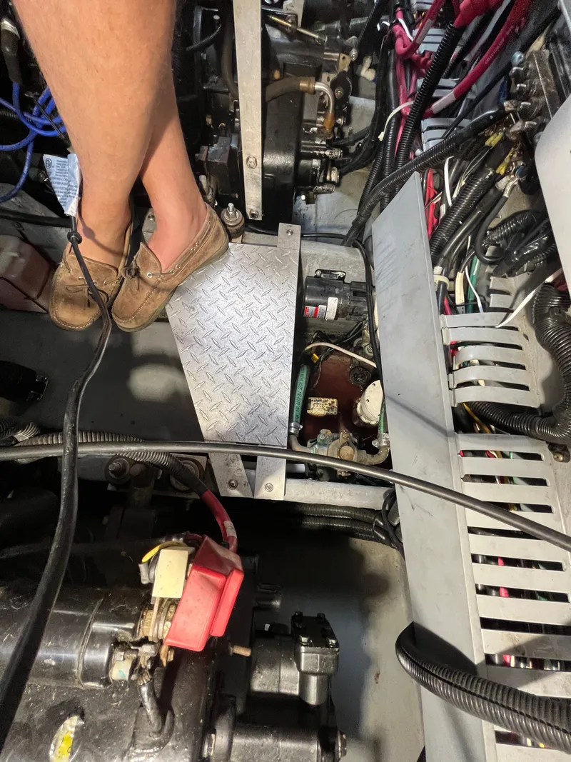Slide: The Image of Engine room of a 1999 Sea Ray 400 Sundancer with visible wiring and components. - 13