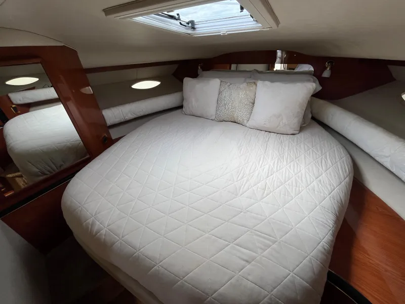 Slide: The Image of Luxurious cabin interior of 1999 Sea Ray 400 Sundancer yacht with plush bedding. - 21