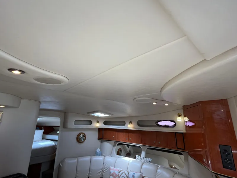 Slide: The Image of Interior of 1999 Sea Ray 400 Sundancer yacht with elegant seating and wood cabinetry. - 24