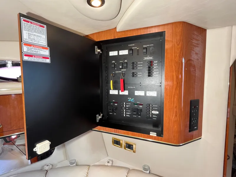 Slide: The Image of Electrical panel inside 1999 Sea Ray 400 Sundancer yacht, featuring switches and controls. - 25