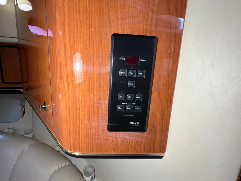 Slide: The Image of Control panel on 1999 Sea Ray 400 Sundancer yacht, mounted on wooden interior. - 26