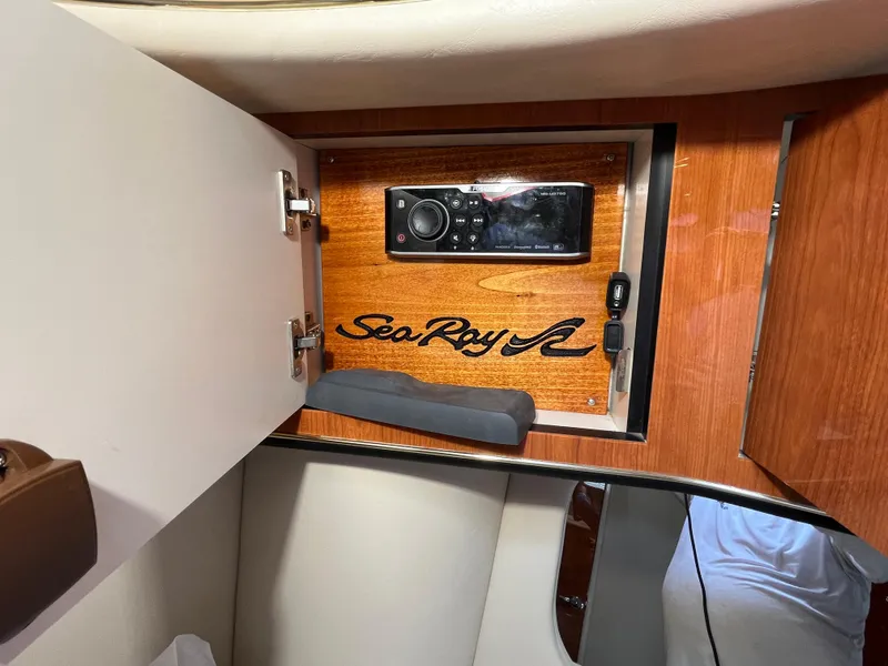 Slide: The Image of 1999 Sea Ray 400 Sundancer interior cabinet with audio system and logo. - 28