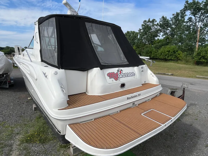 Slide: The Image of 1999 Sea Ray 400 Sundancer yacht with black canopy, docked in Rochester, NY. - 29