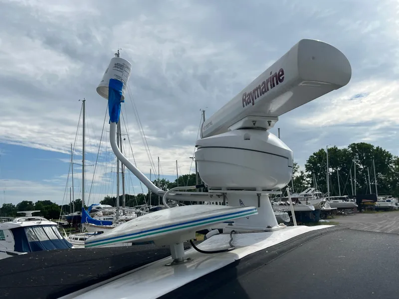 Slide: The Image of Radar equipment on a 1999 Sea Ray 400 Sundancer yacht, docked at a marina. - 34