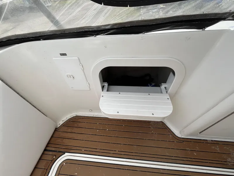 Slide: The Image of 1999 Sea Ray 400 Sundancer interior with storage compartment and wooden flooring. - 37