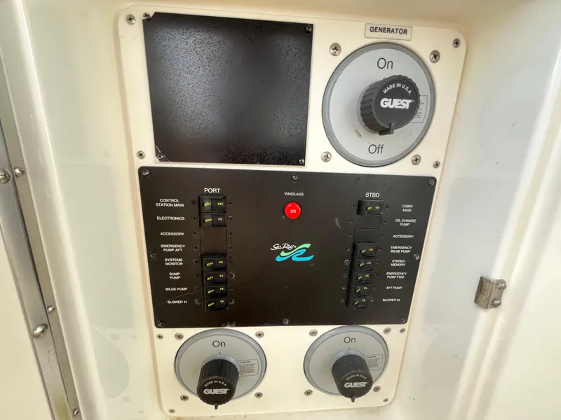 Slide: The Image of Control panel of a 1999 Sea Ray 400 Sundancer boat with switches and dials. - 38