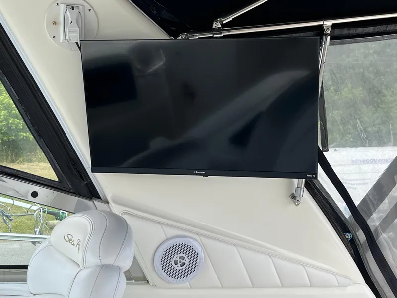 Slide: The Image of Flat-screen TV on 1999 Sea Ray 400 Sundancer yacht interior with white seating. - 46