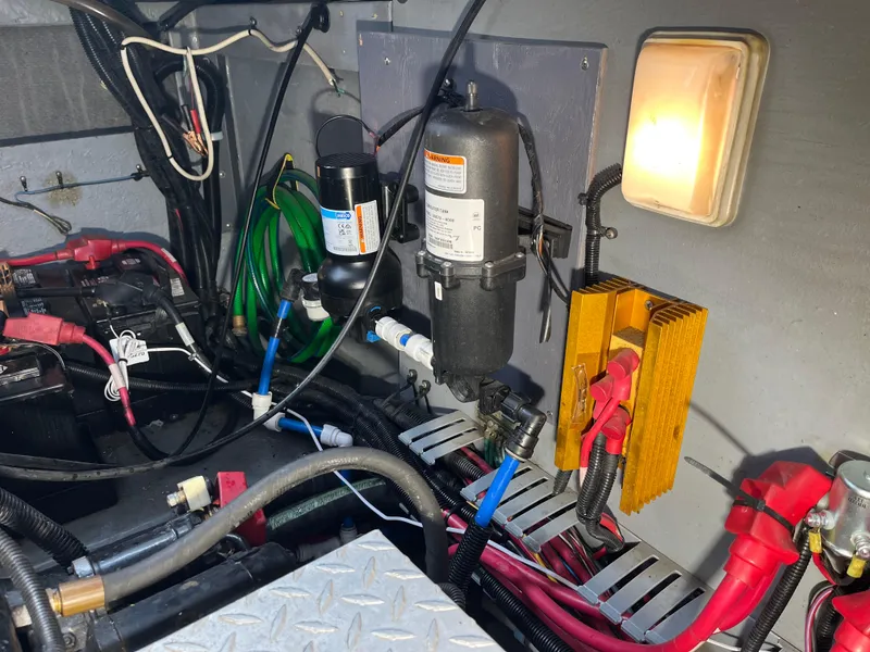 Slide: The Image of Engine room of a 1999 Sea Ray 400 Sundancer with electrical components and wiring. - 5