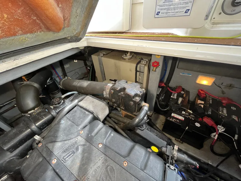 Slide: The Image of Engine compartment of a 1999 Sea Ray 400 Sundancer with visible components and batteries. - 9