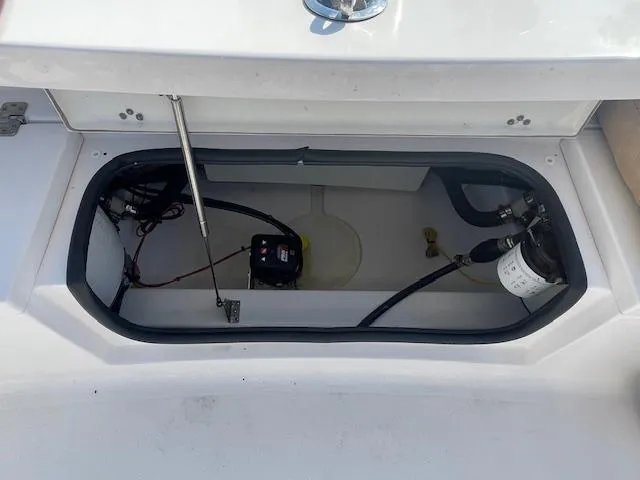 Slide: The Image of Open storage compartment in a 2020 Sportsman 221 Heritage boat, showing internal components. - 11