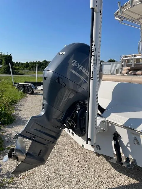 Slide: The Image of 2020 Sportsman 221 Heritage boat with Yamaha outboard motor, parked on gravel. - 12