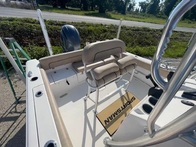 Slide: The Image of 2020 Sportsman 221 Heritage boat interior with seating and console, parked outdoors. - 5