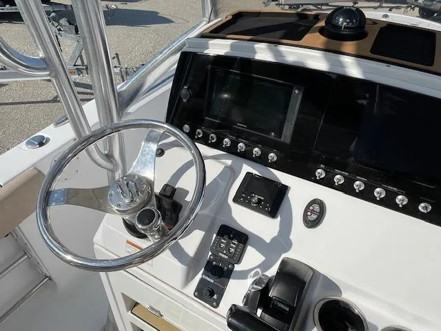 Slide: The Image of 2020 Sportsman 221 Heritage boat dashboard with steering wheel and control panel. - 6