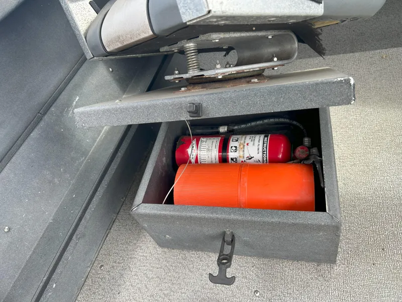 Slide: The Image of Storage compartment in a 1999 Hewescraft Sea Runner 179 with safety equipment. - 10
