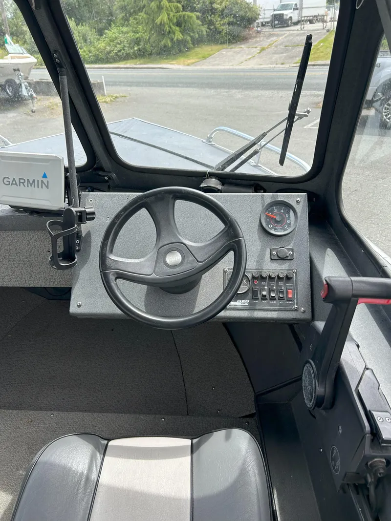 Slide: The Image of 1999 Hewescraft Sea Runner 179 dashboard with steering wheel and Garmin navigation system. - 12