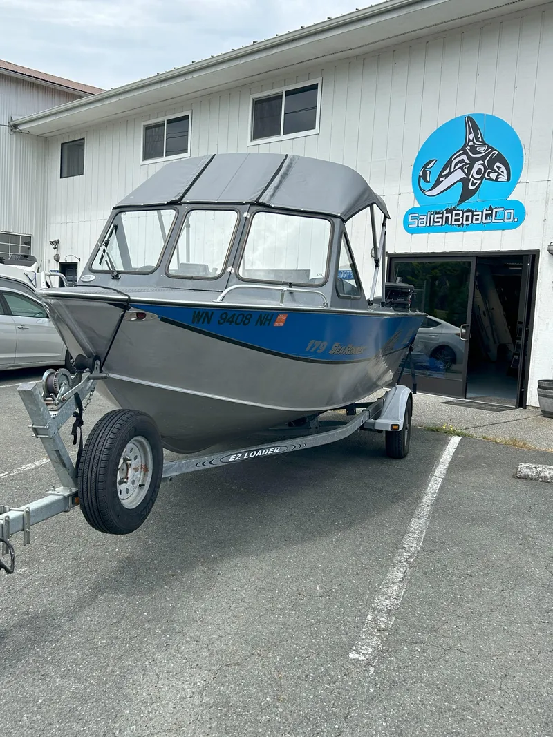 Slide: The Image of 1999 Hewescraft Sea Runner 179 boat on trailer outside Salish Boat Co. building. - 16