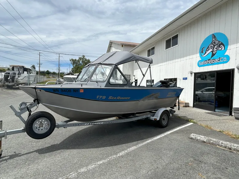 Slide: The Image of 1999 Hewescraft Sea Runner 179 boat on trailer outside Salish Boat Co. building. - 2
