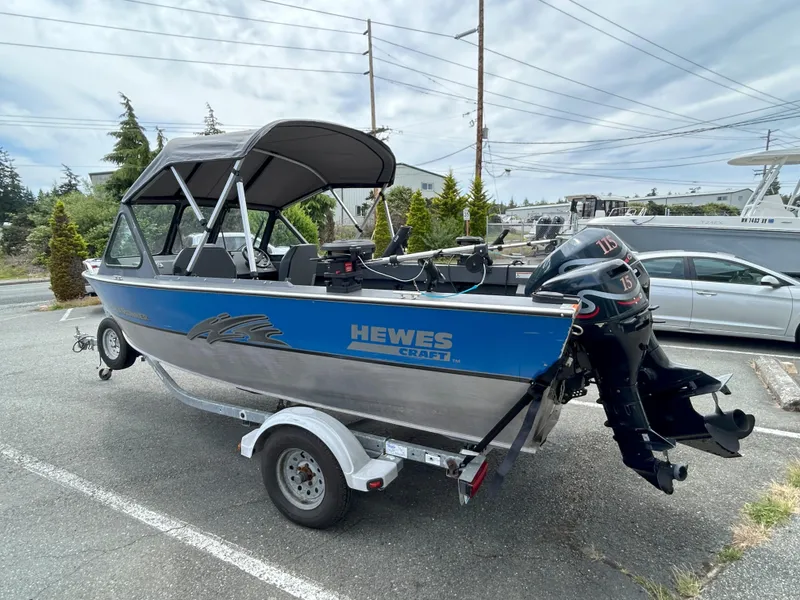 Slide: The Image of 1999 Hewescraft Sea Runner 179 boat on trailer, parked outdoors. - 3