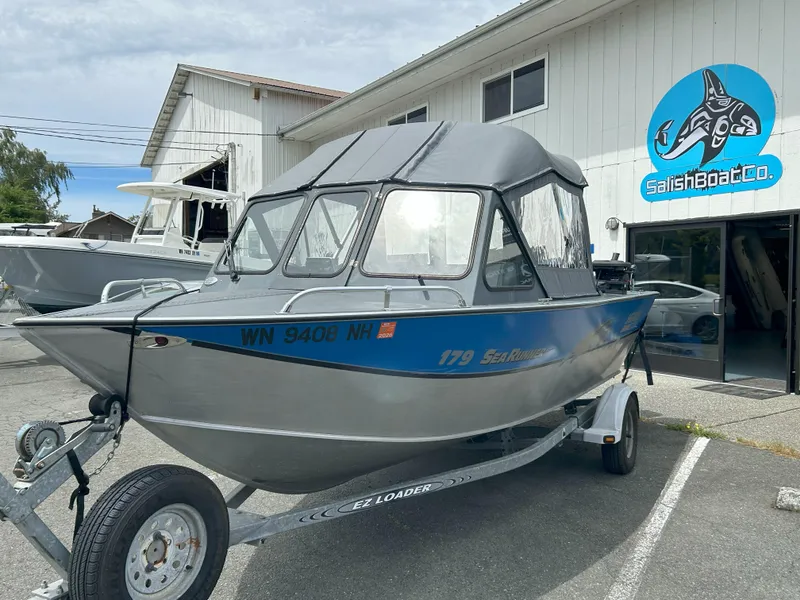 Slide: The Image of 1999 Hewescraft Sea Runner 179 boat on trailer outside Salish Boat Co. - 7
