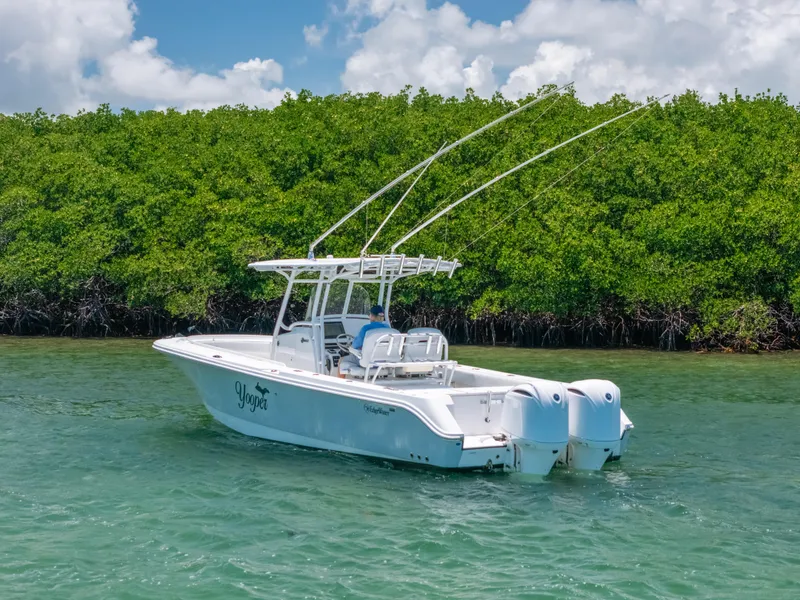 Slide: The Image of 2017 Edgewater 318CC boat on water near lush green mangroves. - 11